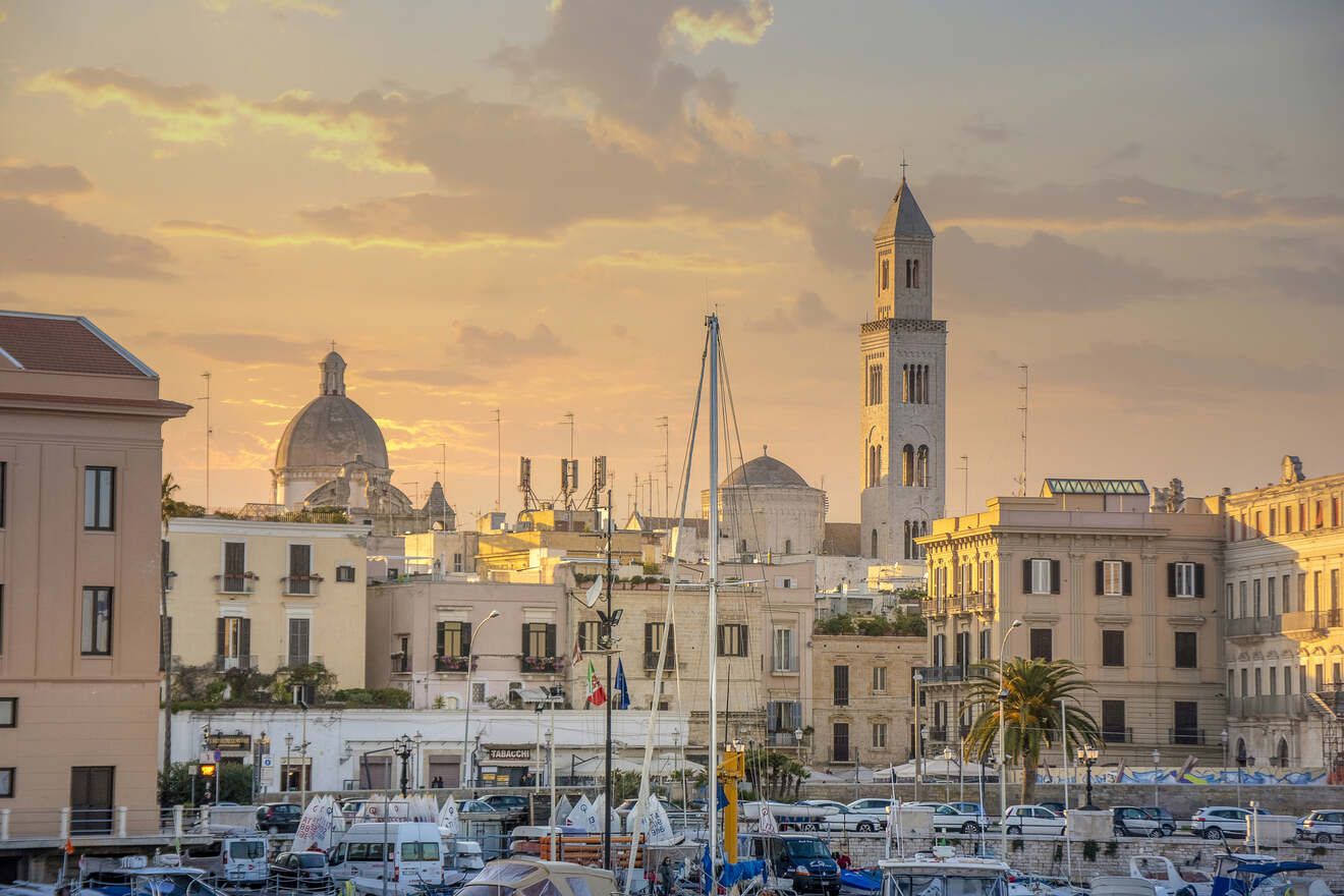 cityscape with buildings and church in the background with parked boats in foreground